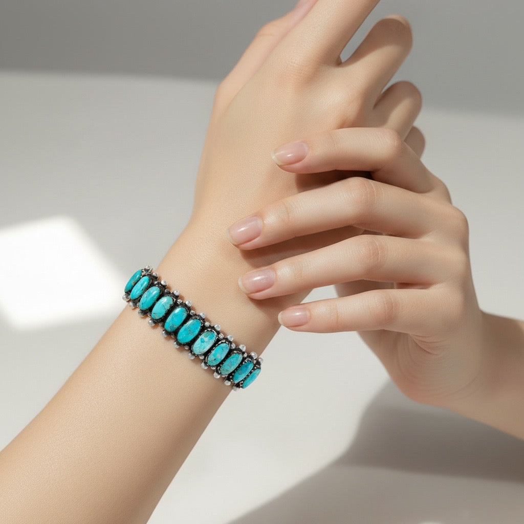 Turquoise beaded bracelet on a wrist with a neutral background